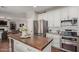 Bright kitchen features a wood island, stainless steel appliances, and white cabinets at 6576 W Lone Cactus Dr, Glendale, AZ 85308