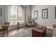 Cozy living room featuring a large window with natural light and vintage decor at 6576 W Lone Cactus Dr, Glendale, AZ 85308