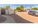 Spacious parking area with room for a car, block wall for privacy and desert landscaping at 6576 W Lone Cactus Dr, Glendale, AZ 85308