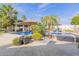Resort-style backyard pool with a built-in spa, lush landscaping, and outdoor seating at 6576 W Lone Cactus Dr, Glendale, AZ 85308