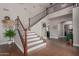 Beautiful staircase with rod iron railing ascending to the second floor at 6576 W Lone Cactus Dr, Glendale, AZ 85308