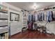 Spacious walk-in closet with custom shelving, drawers, and ample storage space for clothes and accessories at 6576 W Lone Cactus Dr, Glendale, AZ 85308