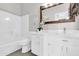 Bathroom showcasing modern white vanity with white quartz countertops, sink, and decorative flowers at 7006 E Jensen St # 33, Mesa, AZ 85207
