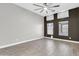 Spacious bedroom with wood-look tile flooring, ceiling fan, and two windows at 7006 E Jensen St # 33, Mesa, AZ 85207
