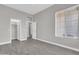 Neutral bedroom featuring wood-look tile, bright windows, ceiling fan, and access to en-suite bathroom at 7006 E Jensen St # 33, Mesa, AZ 85207
