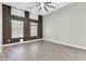 Bedroom with wood-look tile flooring, ceiling fan, and two windows at 7006 E Jensen St # 33, Mesa, AZ 85207