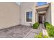 Welcoming entryway with custom brickwork, mature plants, and an attractive front door at 7006 E Jensen St # 33, Mesa, AZ 85207