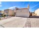 Inviting single-story home featuring a spacious driveway and low-maintenance desert landscape at 7006 E Jensen St # 33, Mesa, AZ 85207
