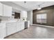 Bright kitchen featuring white cabinets, quartz countertops, stainless steel appliances, and wood-look tile flooring at 7006 E Jensen St # 33, Mesa, AZ 85207