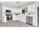 Kitchen featuring stainless steel appliances, quartz countertops, white cabinets, and wood-look tile flooring at 7006 E Jensen St # 33, Mesa, AZ 85207