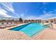 Community pool area with lounge chairs, pool, fencing, and a ramada under a sunny sky at 7006 E Jensen St # 33, Mesa, AZ 85207