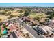 An aerial view of a residential neighborhood with lush green spaces, swimming pools, and houses with solar panels at 751 W Elgin St, Chandler, AZ 85225