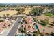 An aerial view showcasing multiple properties with pools and mature trees, located near a lush, green golf course at 751 W Elgin St, Chandler, AZ 85225