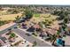 A high-angle aerial showing multiple tile-roofed homes near a golf course, showcasing the neighborhood's layout at 751 W Elgin St, Chandler, AZ 85225