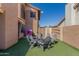 Backyard featuring an artificial turf area and gray outdoor seating around a firepit at 751 W Elgin St, Chandler, AZ 85225