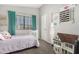 Charming bedroom with a dollhouse, a white crib, and artistic wall decorations creating a delightful space at 751 W Elgin St, Chandler, AZ 85225