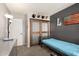 Bedroom featuring an accent wall, decorative accents, and a wooden sliding door for rustic charm at 751 W Elgin St, Chandler, AZ 85225