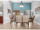 Dining room featuring light blue accent wall, view to the patio, and decorative wall art at 751 W Elgin St, Chandler, AZ 85225