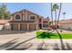 Two-story home showcasing a three-car garage, desert landscaping, and a red tile roof at 751 W Elgin St, Chandler, AZ 85225