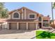 Two-story home showcasing a three-car garage, desert landscaping, and a red tile roof at 751 W Elgin St, Chandler, AZ 85225