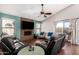 Cozy living room showcasing a stone fireplace, hardwood floors and a ceiling fan at 751 W Elgin St, Chandler, AZ 85225