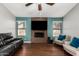 Living room showcasing a stone fireplace, hardwood floors, a ceiling fan and windows at 751 W Elgin St, Chandler, AZ 85225