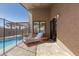 Relaxing patio with a lounger chair next to the pool, perfect for soaking up the sun and enjoying the backyard at 751 W Elgin St, Chandler, AZ 85225
