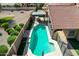 Aerial view of a private pool featuring a diving board, pergola with seating, and well-manicured landscaping at 751 W Elgin St, Chandler, AZ 85225