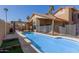 Backyard pool and outdoor patio area with pergola and palm trees under a bright blue sky at 751 W Elgin St, Chandler, AZ 85225