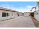 Spacious backyard with a large stamped concrete patio, mature landscaping, and detached storage at 7538 E Forge Ave, Mesa, AZ 85208