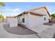 Exterior view of the property, featuring siding, windows, and outdoor storage at 7538 E Forge Ave, Mesa, AZ 85208