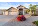 Charming single-Gathering home with a three-car garage, desert landscaping, and an arched entryway at 7538 E Forge Ave, Mesa, AZ 85208