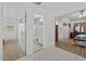 A hallway leading to a bathroom, closet, and primary bedroom at 7538 E Forge Ave, Mesa, AZ 85208