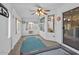 Bright sunroom with carpet flooring, a ceiling fan, and multiple windows for natural light at 7538 E Forge Ave, Mesa, AZ 85208