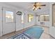 Bright sunroom with carpet flooring, a ceiling fan, and multiple windows for natural light at 7538 E Forge Ave, Mesa, AZ 85208