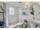 A well-lit bathroom featuring a walk-in shower, pedestal sink, and modern fixtures at 7601 E 2Nd St # 20, Scottsdale, AZ 85251