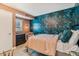 This bedroom features a wallpapered accent wall and neutral-colored walls, creating a serene and stylish atmosphere at 7601 E 2Nd St # 20, Scottsdale, AZ 85251