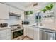 Well-lit kitchen with stainless steel appliances, ample counter space, and open shelving for a modern feel at 7601 E 2Nd St # 20, Scottsdale, AZ 85251