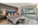 Serene main bedroom with a cozy bed, decorative wallpaper, natural light, and chic decor at 7601 E 2Nd St # 20, Scottsdale, AZ 85251