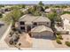 Ariel view of beige two-story house, a three car garage, and desert landscaping at 802 N Butte Ave, Chandler, AZ 85226