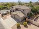 Aerial view of the exterior of a beige two-story home and three car garage at 802 N Butte Ave, Chandler, AZ 85226