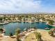 Scenic aerial view showcasing a large lake with recreational amenities in a vibrant community setting with mountain views at 802 N Butte Ave, Chandler, AZ 85226