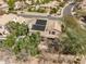 Expansive aerial view of a home with solar panels, lush greenery, and a private pool in a residential neighborhood at 802 N Butte Ave, Chandler, AZ 85226