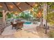 Charming backyard featuring a shaded patio, dining set, and a lush green landscape, perfect for outdoor gatherings at 802 N Butte Ave, Chandler, AZ 85226