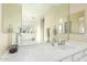Well-lit bathroom with white cabinets, mirrors, and tile flooring at 802 N Butte Ave, Chandler, AZ 85226