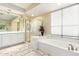 Bright bathroom featuring a garden tub, glass shower, and tile flooring at 802 N Butte Ave, Chandler, AZ 85226