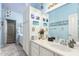 Bathroom with blue walls, lots of counter space, white cabinets, and vanity sink at 802 N Butte Ave, Chandler, AZ 85226