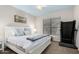 Bedroom with a large bed, carpet flooring, ceiling fan, and natural light from the window at 802 N Butte Ave, Chandler, AZ 85226