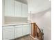 Hallway area showcasing white cabinets, shelving, and a wooden railing to stairs at 802 N Butte Ave, Chandler, AZ 85226