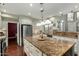 Bright kitchen with stainless steel appliances, granite counters, and a large center island at 802 N Butte Ave, Chandler, AZ 85226
